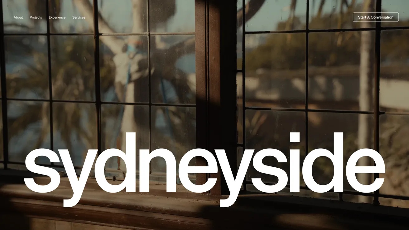 Sydneyside Contracting’s home page: the word ‘sydneyside’ in large white type over footage of palms and the harbour.